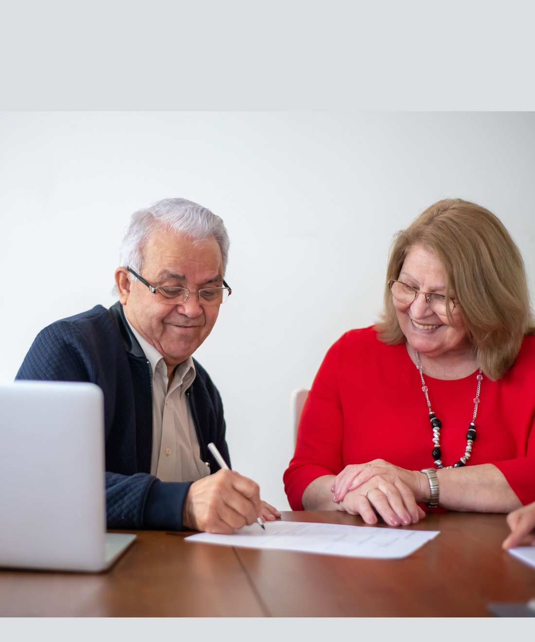 A couple signing their Will and Lasting Power of Attorney